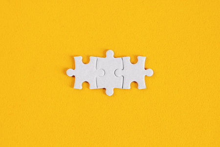 Matching Puzzle Pieces on Yellow Backgroundの写真素材