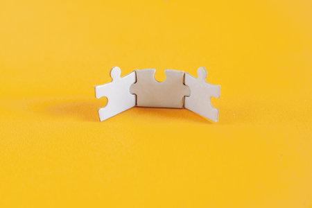 Matching Puzzle Pieces on Yellow Backgroundの写真素材