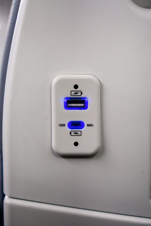 USB charging port for electronic devices on airplane seatの写真素材