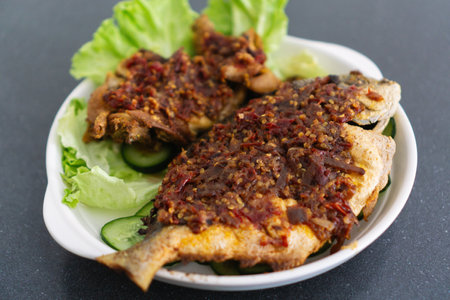 Ikan Goreng Masak Sambal, Fried Fish with Chile Paste. Traditional Indonesian and Malaysian Dishの写真素材