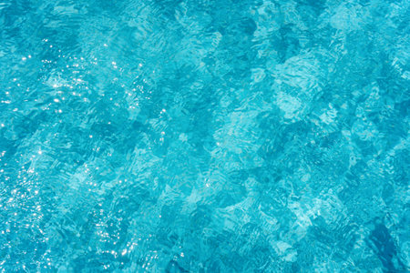 Clear blue pool water shimmering in the sunlight.の写真素材