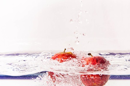 Red apples in clear water