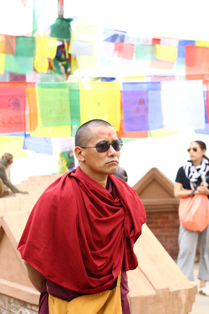 Kathmandu, Nepal - Tibetian monk wears sunglasses  April 13, 2014のeditorial素材