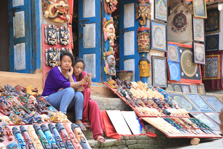 Nagarkot, Nepal - Nepalese teenagers use mobile phone in Nagarkot hill on April 17, 2014のeditorial素材