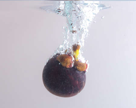 Mangosteen in water splashの写真素材