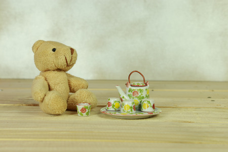 teddy bear sit next to mini tea setの写真素材