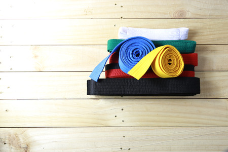 Color belt of martial art on wood floorの写真素材