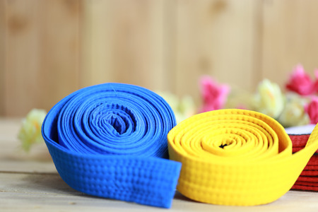 Color belt of martial art on wood floorの写真素材