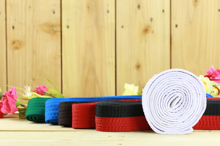 Color belt of martial art on wood floorの写真素材