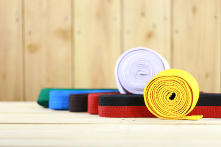 Color belt of martial art on wood floorの写真素材