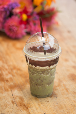 Green tea smoothie in plastic cup with lid and strawの写真素材