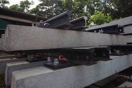 pile of concrete railroad tie with train as backgroundの写真素材