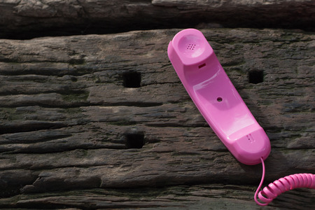 Pink telephone on old talble in nature