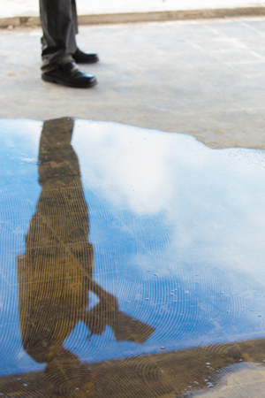Asian male worker in yellow hard helmet and vest as for safety in underconstructed building as survey and checking projectの写真素材