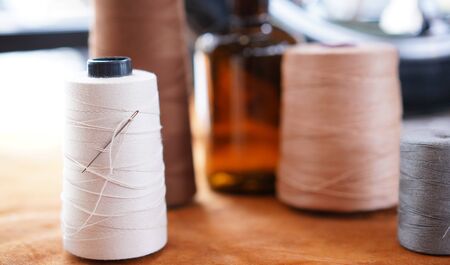 White thread with small needle and color thread in hobby sewing room. Craft instrumentの写真素材