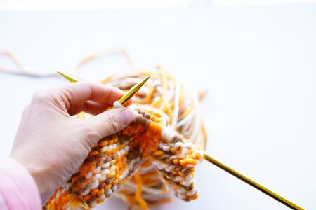 Knitting wool or woven yarn with metal stick as leisure of woman handicraft. Handmade scarf of wool...