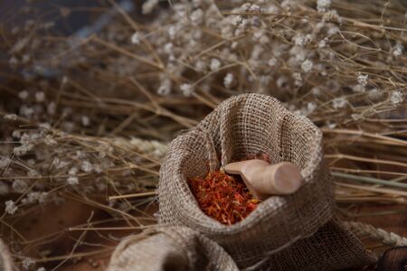 Spicy condiment, herbal aroma dry food for Asian cookin on wood  cutter with dry seed and colorful powder for kitchen ingredientの写真素材