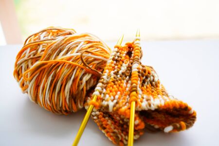 Knitting wool or woven yarn with metal stick as leisure of woman handicraft. Handmade scarf of wool...