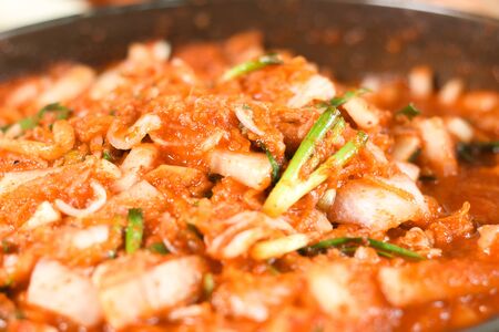 Kimchi,Korean cuisine famous side dish, traditional side dish and fermented vegetables, cabbage and radish, spicy and smelly seasonings including apple or pear, onions, garlic, ginger, spring, onion and mushroom.の写真素材