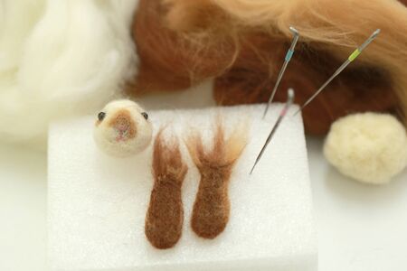 Needle felt, wool weaving handmade craft by sheep hair. Sheep hair wool made by needle press to be doll.の写真素材