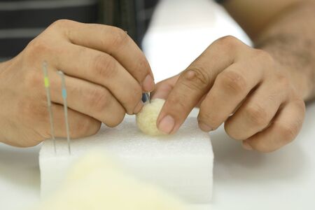 Needle felt, wool weaving handmade craft by sheep hair. Sheep hair wool made by needle press to be...