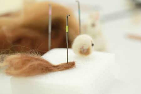 Needle felt, wool weaving handmade craft by sheep hair. Sheep hair wool made by needle press to be doll.の写真素材