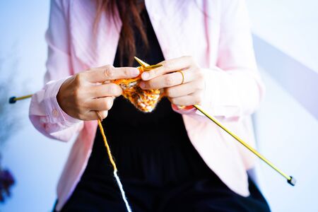 Knitting wool or woven yarn with metal stick as leisure of woman handicraft. Handmade scarf of wool...