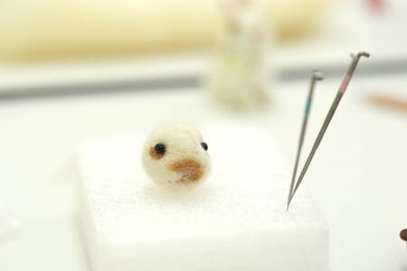 Needle felt, wool weaving handmade craft by sheep hair. Sheep hair wool made by needle press to be doll.の写真素材