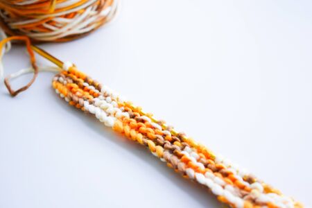 Knitting wool or woven yarn with metal stick as leisure of woman handicraft. Handmade scarf of wool tread as knitwear for warm clothの写真素材