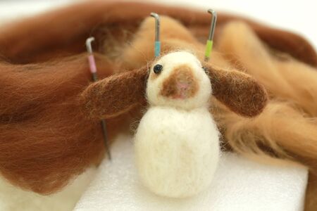Needle felt, wool weaving handmade craft by sheep hair. Sheep hair wool made by needle press to be doll.の写真素材