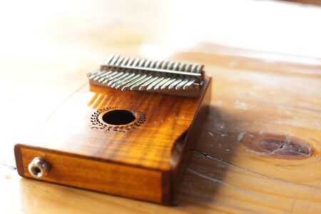 Kalimba or mbira is an African musical instrument.Traditional to the Shona people of Zimbabwe. Kalimba made from  wooden board with metal, play on  hands and plucking the tines with the thumbsの写真素材