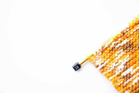 Knitting wool or woven yarn with metal stick as leisure of woman handicraft. Handmade scarf of wool tread as knitwear for warm clothの写真素材