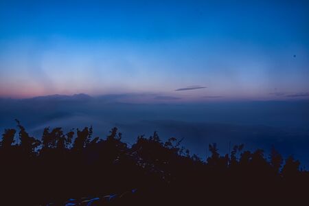The Himalayan mountains covered with clouds in the early morning of autumn. From Tiger Hillの写真素材