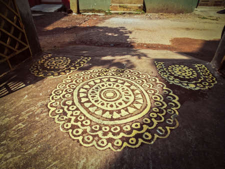 The door of the house is beautifully decorated by Alpona.