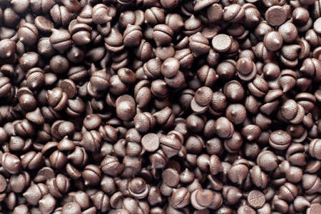 top view of dark chocolate chips scattered on floor