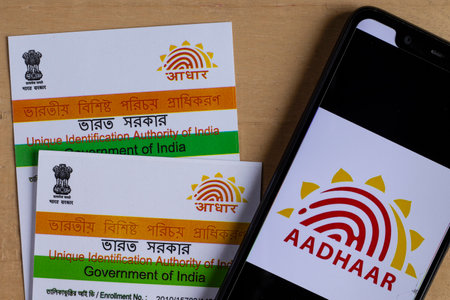 Birbhum, West Bengal / India - 18th August 2020: Aadhaar cards and smart phone with mAadhaar app on...