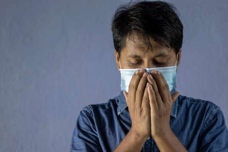 health problem and people concept - unhealthy indian man coughing with nose mask on