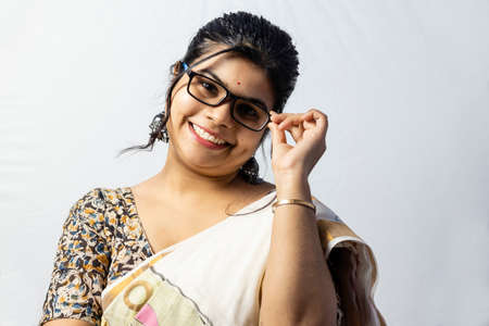 Isolated on white background an Indian office woman in saree posing with her eyeglasses