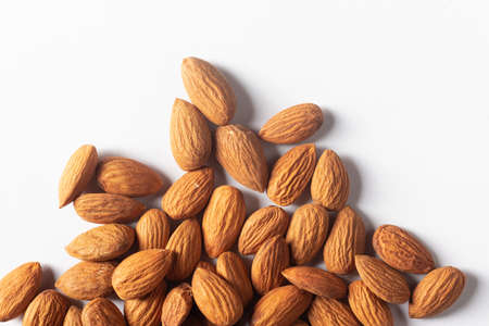 Close up top view of almond nuts on white backgroundの写真素材