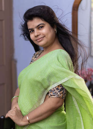 Portrait of a beautiful Indian woman in green saree