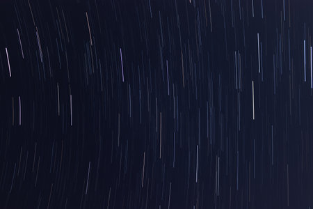star trails in dark starry night skyの写真素材