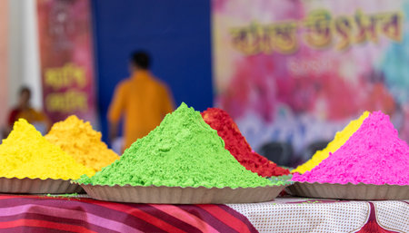 Heaps of colorful powder paints arranged in plates during holi festivalの写真素材