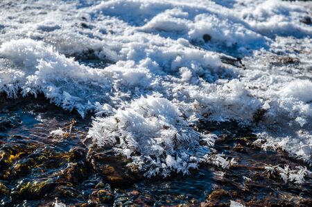 Big crystals of hoarfrost on a cold waterの写真素材