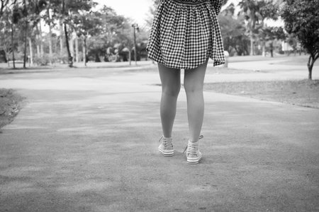 Woman walking cross road in black and white toneの写真素材