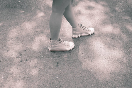 Woman walking cross road in black and white toneの写真素材