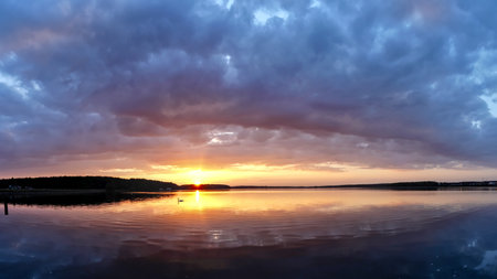 A beautiful sunset over Rybnickie Lake in Julyの写真素材