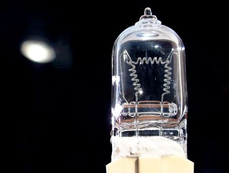 Halogen projector lamp illuminated from behindの写真素材