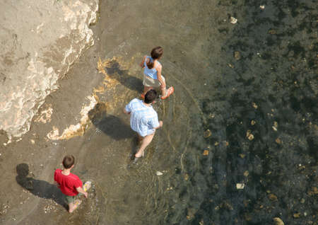Family Walking in waterの写真素材