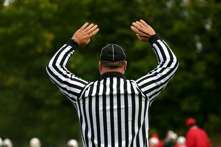 The football referee signals that the touchdown attempt was successfulの写真素材