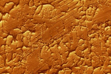 a close up of a brown stucco wall 